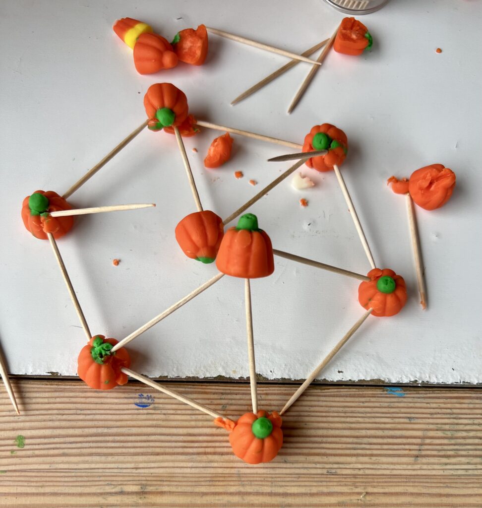 Toothpicks stuck into pumpkin candies, creating a geodesic dome shape.