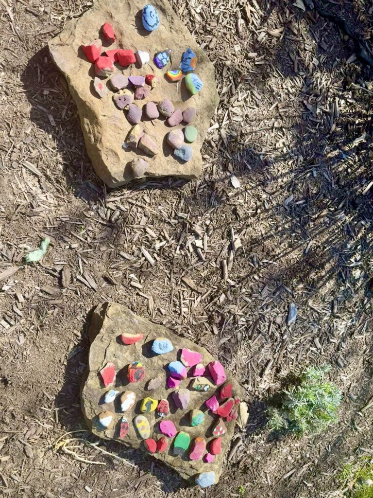Stacks of painted stones laying on larger stones